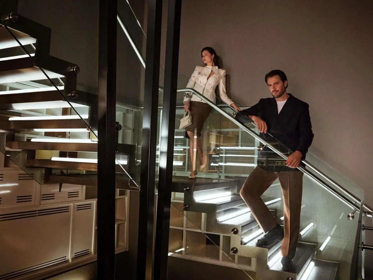 a man and a woman walking down an escalator at Pullman London St Pancras in London