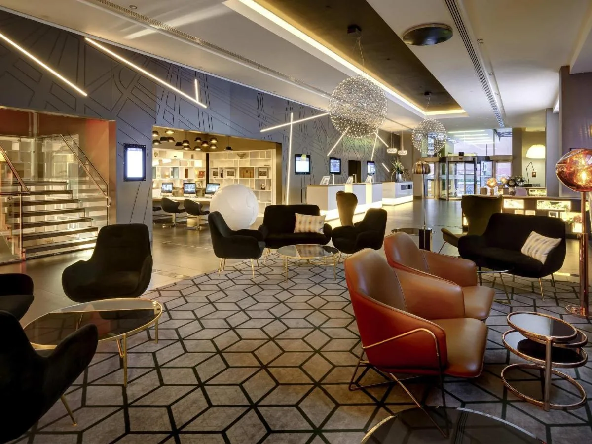 a lobby with chairs and tables in a store at Pullman London St Pancras in London